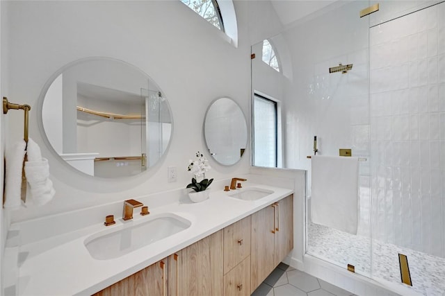 bathroom with vanity, tile patterned floors, a wealth of natural light, and a shower with shower door