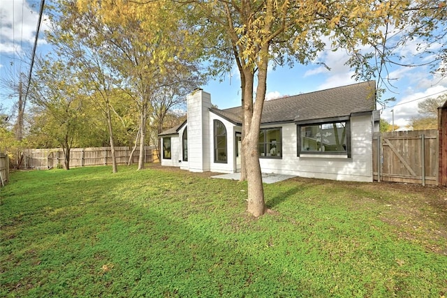 rear view of property featuring a yard