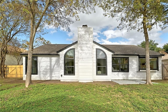 rear view of property featuring a yard and a patio