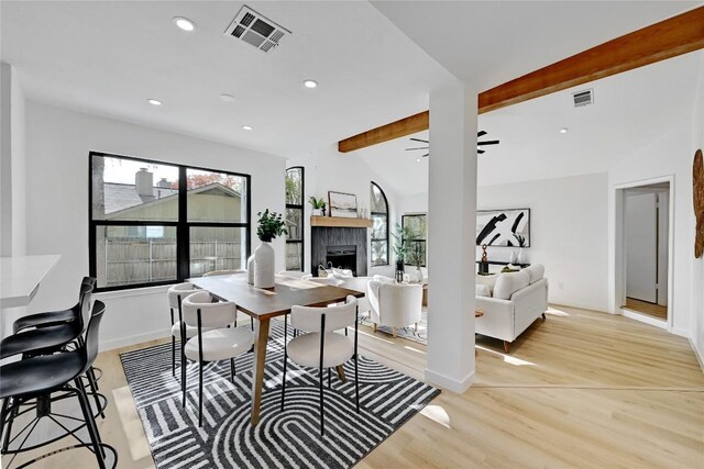 dining space featuring vaulted ceiling with beams, ceiling fan, and light hardwood / wood-style floors