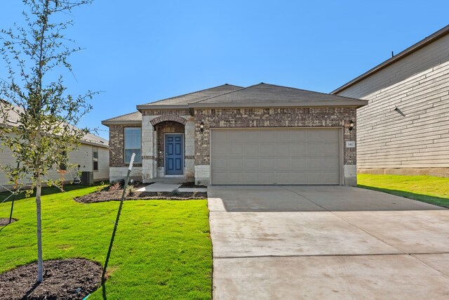 view of front of house with a garage, central air condition unit, and a front lawn