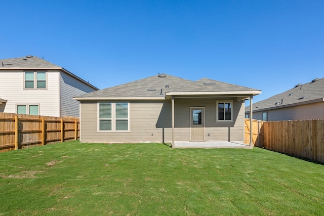 rear view of house with a patio area and a yard