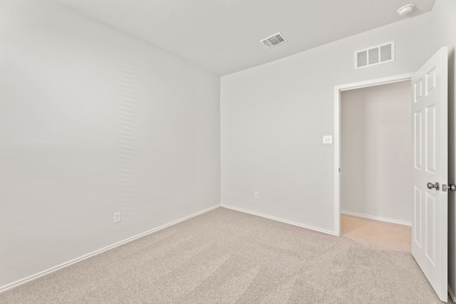 unfurnished room with light colored carpet