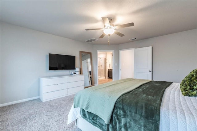 bedroom featuring light carpet, ensuite bath, and ceiling fan