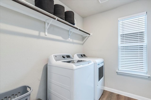 laundry room with dark hardwood / wood-style flooring and separate washer and dryer