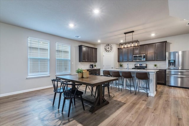 dining room featuring light wood-type flooring and sink