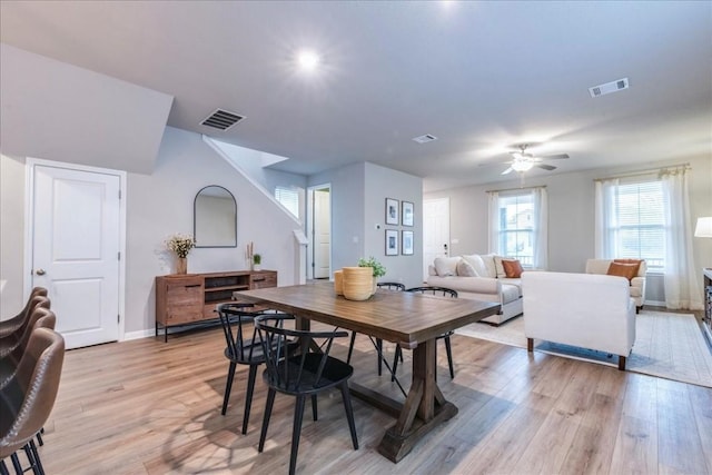 dining area with ceiling fan and light wood-type flooring