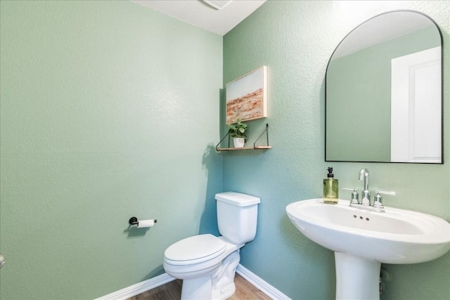 bathroom featuring hardwood / wood-style floors, toilet, and sink