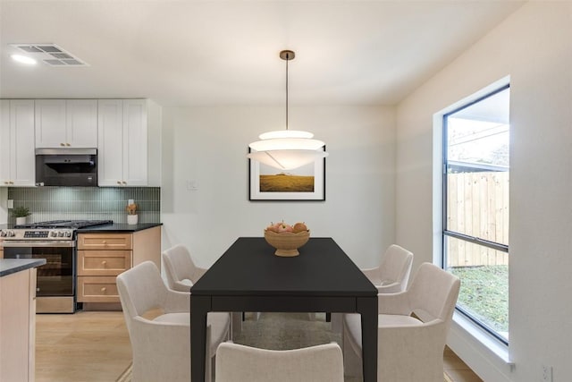 dining space featuring a healthy amount of sunlight and light hardwood / wood-style flooring