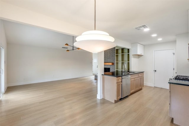 kitchen with dishwasher, sink, hanging light fixtures, a fireplace, and light hardwood / wood-style floors