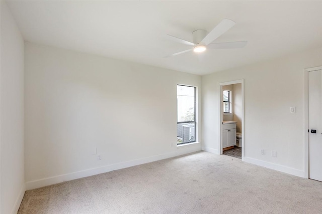 spare room featuring ceiling fan and light colored carpet