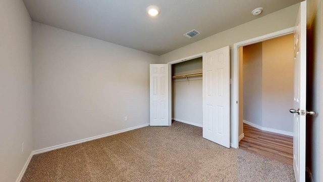 unfurnished bedroom featuring carpet flooring and a closet