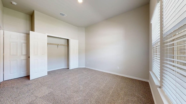 unfurnished bedroom featuring a closet and carpet floors