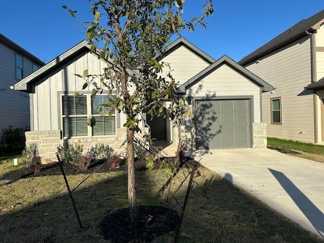 223 Spirit St, Elgin, TX 78621 - view of front of home with concrete driveway and a garage