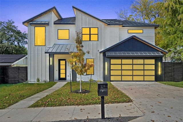 modern farmhouse style home with a garage and a front lawn