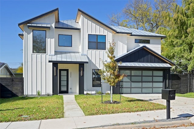 modern farmhouse style home with a garage and a front lawn