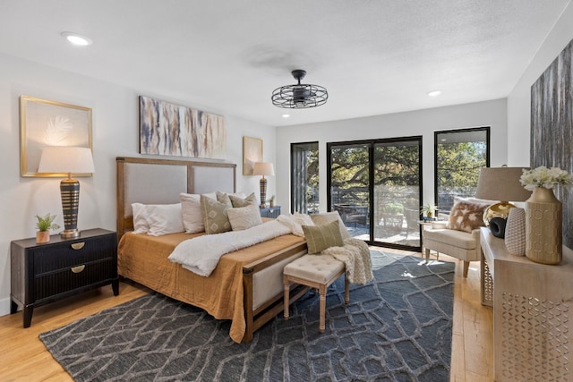 bedroom featuring access to outside and hardwood / wood-style floors