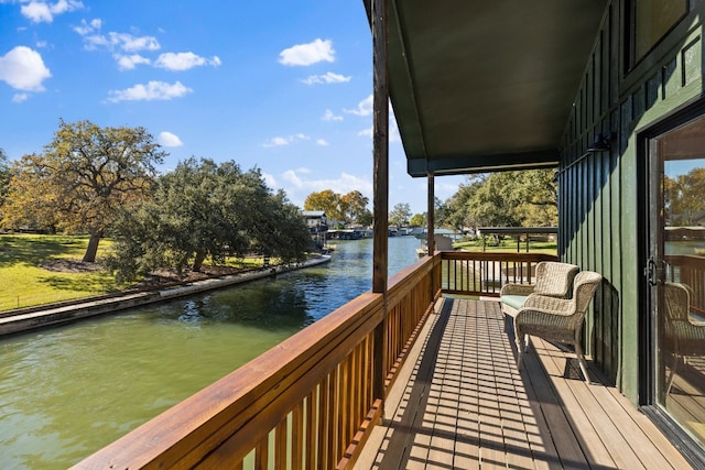 wooden deck featuring a water view