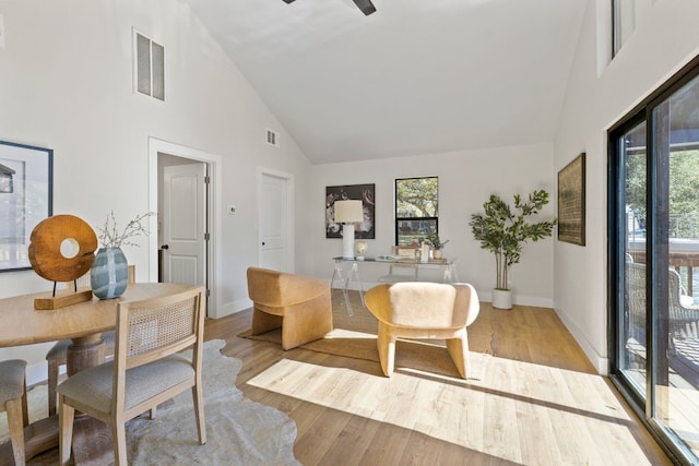 living area with ceiling fan, light hardwood / wood-style flooring, and high vaulted ceiling