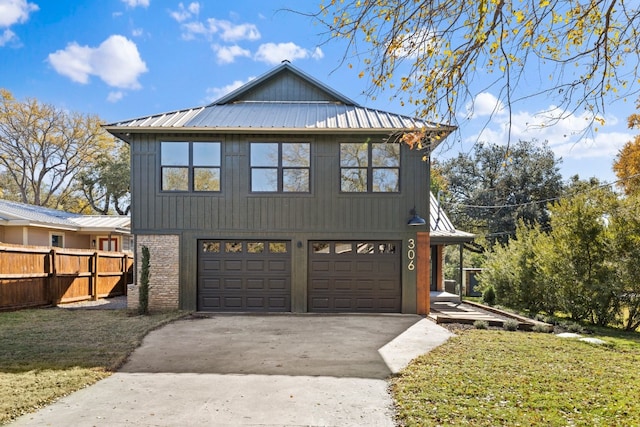 view of front of property with a garage and a front lawn