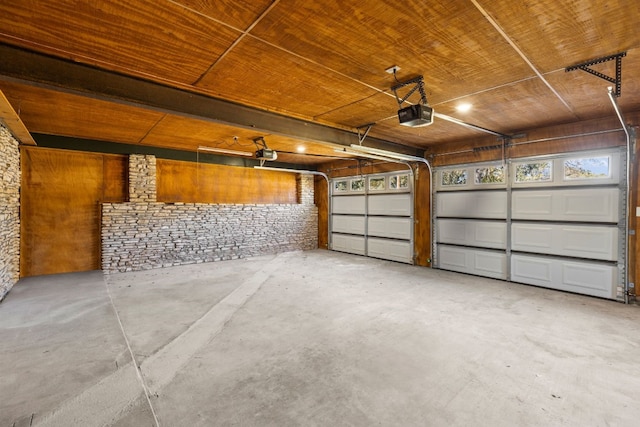 garage featuring a garage door opener and wood ceiling