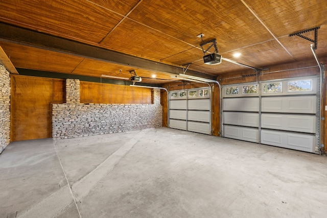 306 Bluebird Cir, Marble Falls, TX 78654 - garage featuring a garage door opener and wood ceiling