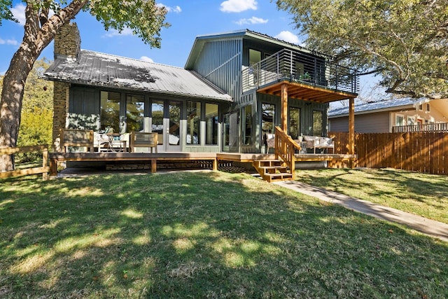 306 Bluebird Cir, Marble Falls, TX 78654 - back of house featuring a balcony, board and batten siding, a metal roof, a chimney, and a deck