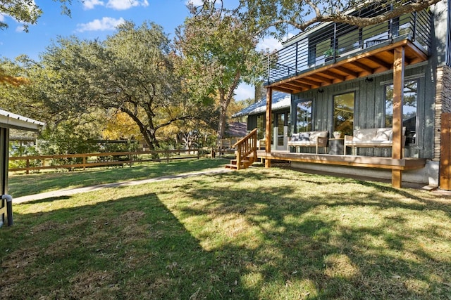 view of yard with a balcony