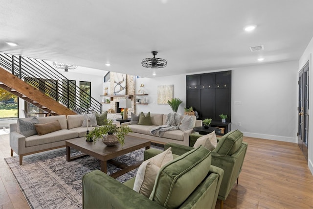 306 Bluebird Cir, Marble Falls, TX 78654 - living area with light wood finished floors, recessed lighting, a brick fireplace, and stairway