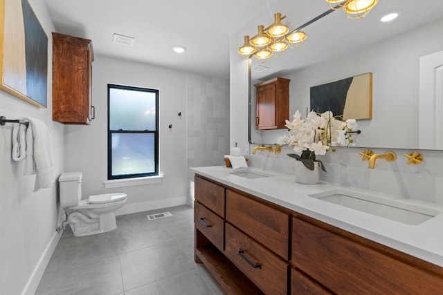 bathroom with tile patterned floors, vanity, and toilet