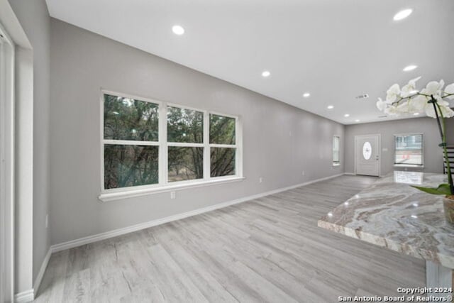 unfurnished living room with light wood-type flooring