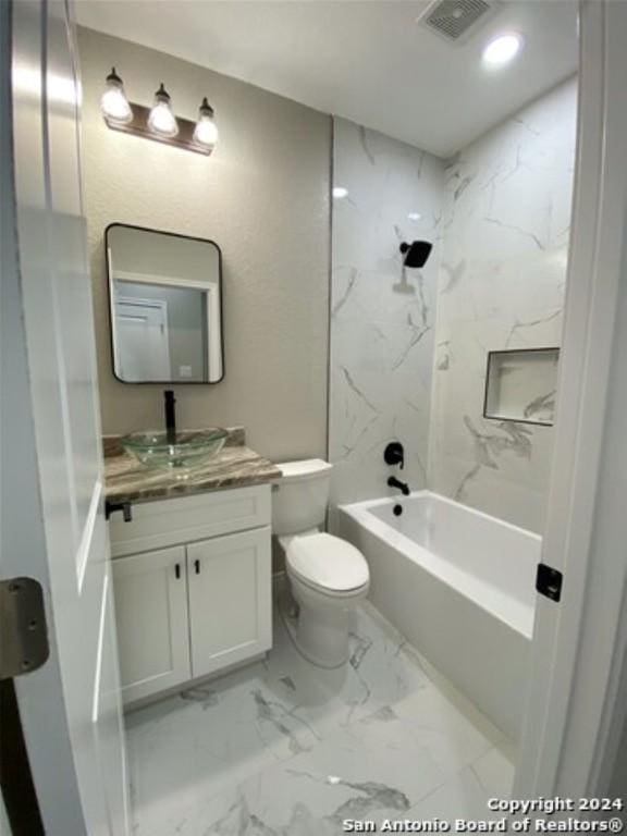 full bathroom with vanity, toilet, and tiled shower / bath combo