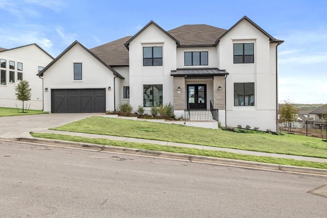 modern farmhouse style home with a garage, french doors, and a front lawn