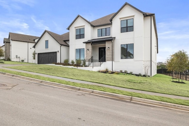 view of front of home with a front yard and a garage