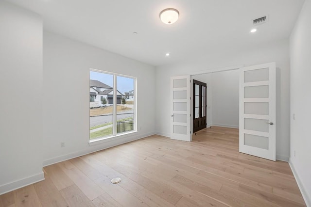 spare room with light wood-type flooring