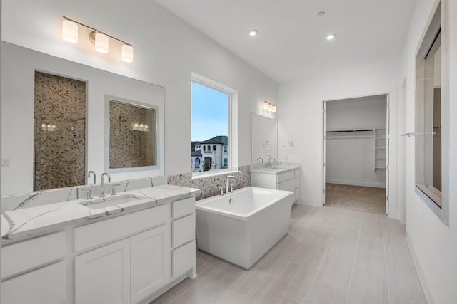 bathroom with tile patterned flooring, vanity, and shower with separate bathtub