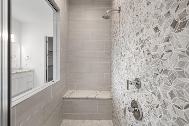 bathroom featuring vanity and tiled shower