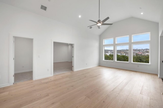 unfurnished living room with ceiling fan, high vaulted ceiling, and light hardwood / wood-style floors