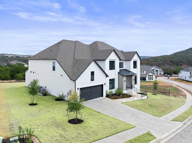 view of front facade featuring a garage and a front lawn