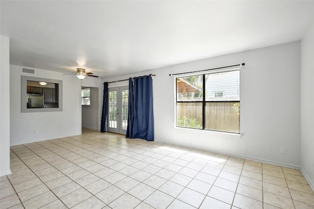 unfurnished room with ceiling fan and light tile patterned floors