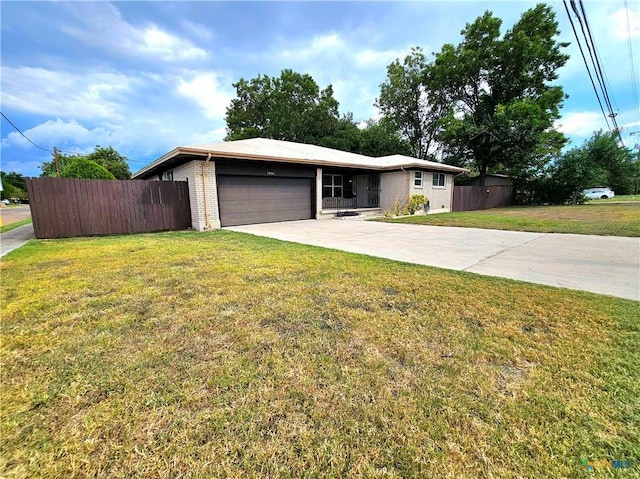 single story home with fence, an attached garage, brick siding, a front yard, and concrete driveway