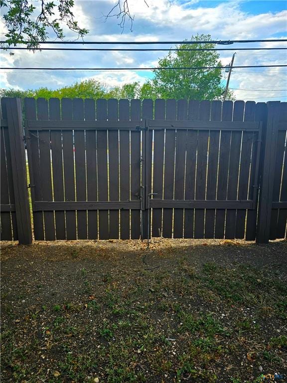 view of gate with fence