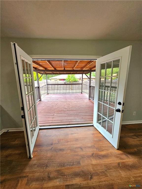 entryway with baseboards, wood finished floors, and french doors