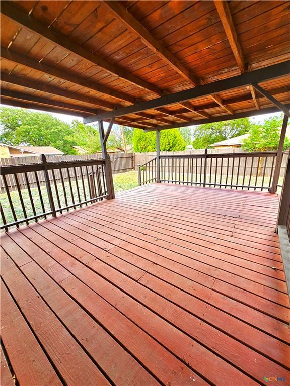 wooden deck featuring a fenced backyard