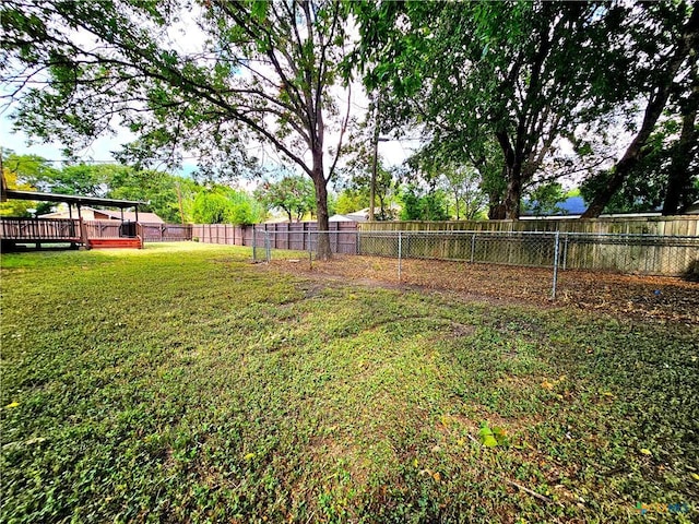 view of yard with a fenced backyard and a deck