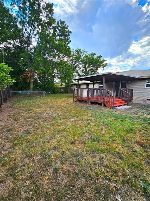 view of yard with fence and a wooden deck