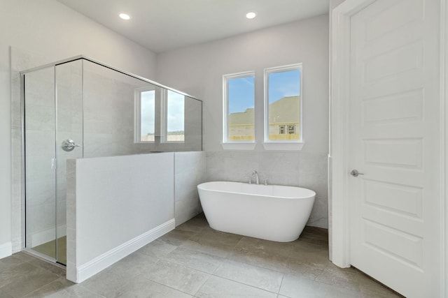 1320 Shelby Ln, Georgetown, TX 78628 - bathroom with a shower stall, a freestanding tub, and recessed lighting