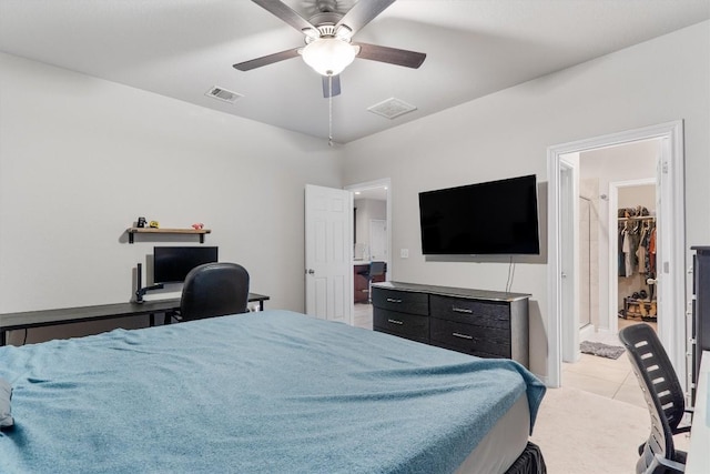 bedroom with ceiling fan, light tile patterned flooring, and a spacious closet