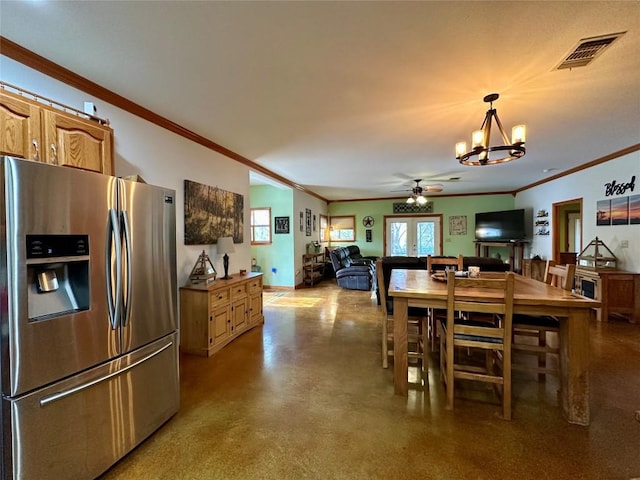 dining area with french doors, ceiling fan with notable chandelier, and crown molding