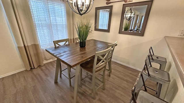 dining room with a notable chandelier and dark hardwood / wood-style flooring